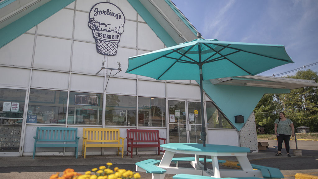 Color coordinated tables umbrellas and benches. Custard Cup Champaign IL commercial furniture customer.