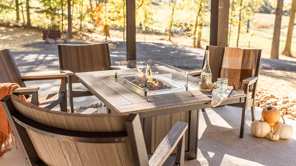 Outdoor dining luxury fire table and large heavy poly chairs.